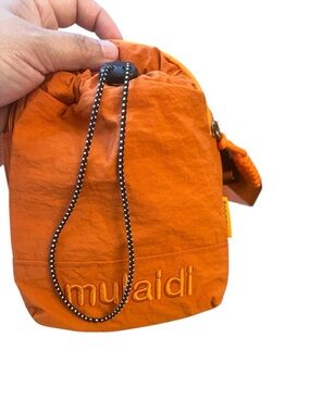 Orange drawstring pouch with embroidered logo